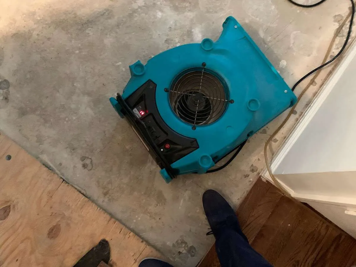 Air mover drying subfloor during Commercial Water Damage Restoration in Claremore